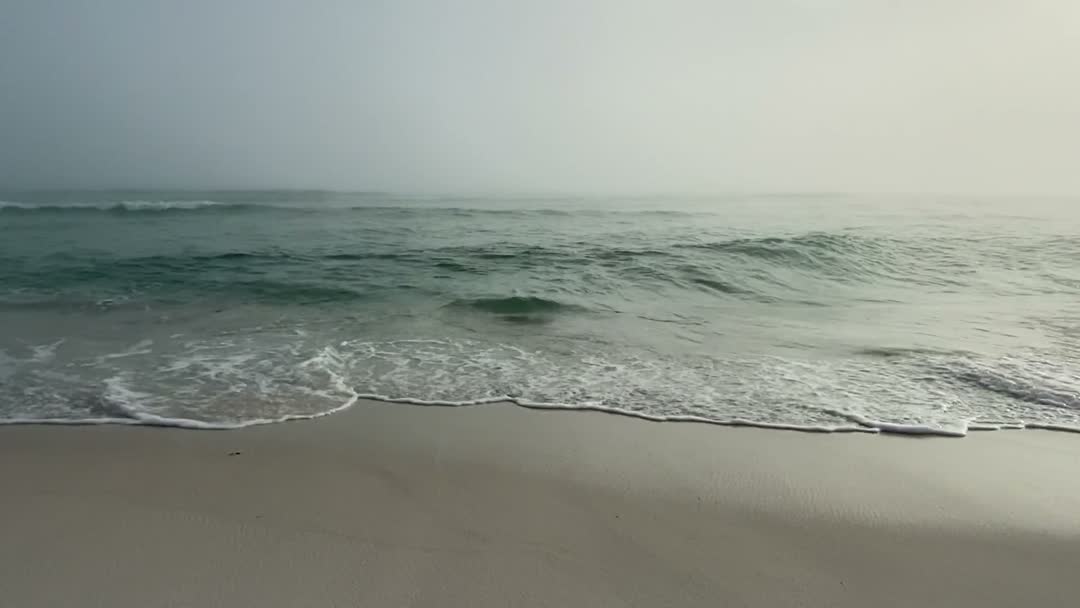 Waves reaching a wide, flat shoreline